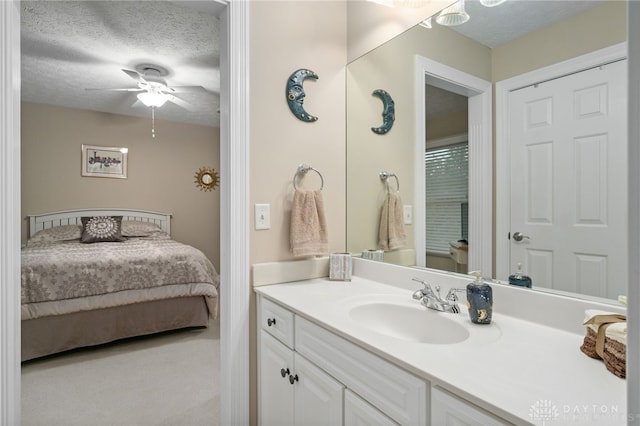 7607 Stone Ridge Dr, Springboro, OH 45066 - ensuite bathroom with vanity, a textured ceiling, and ceiling fan