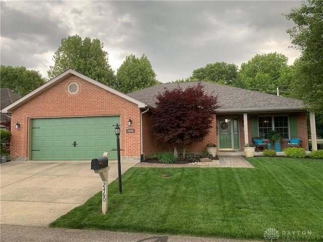 2460 Coriander Ct, Troy, OH 45373 - ranch-style home featuring brick siding, a front lawn, concrete driveway, and an attached garage
