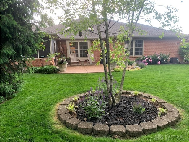 2460 Coriander Ct, Troy, OH 45373 - rear view of house featuring a patio, brick siding, a lawn, and roof with shingles
