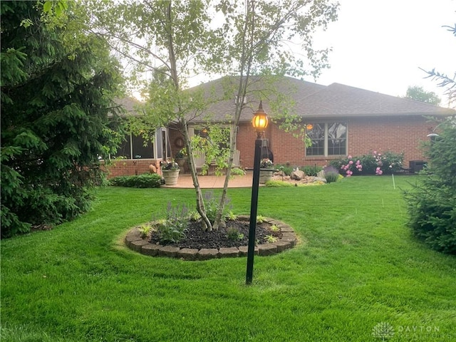 2460 Coriander Ct, Troy, OH 45373 - view of front of property featuring brick siding, a front lawn, and a shingled roof