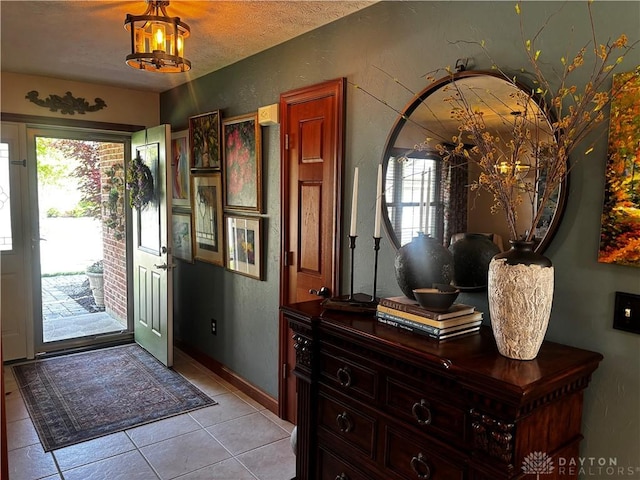 2460 Coriander Ct, Troy, OH 45373 - entrance foyer with plenty of natural light, light tile patterned floors, and a textured wall