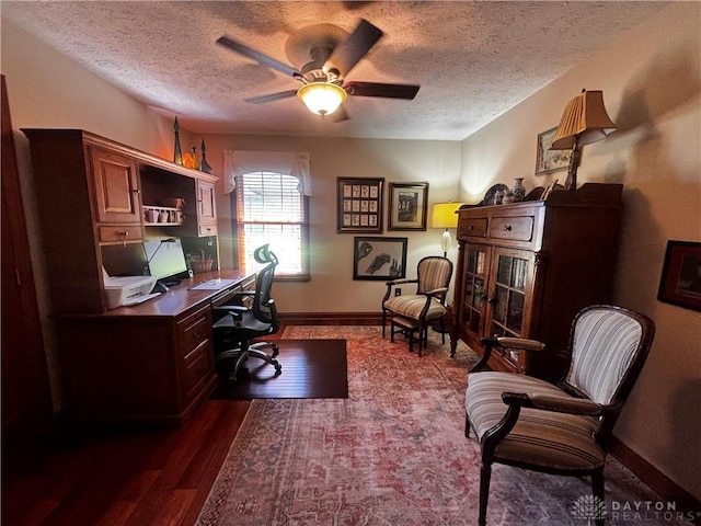 2460 Coriander Ct, Troy, OH 45373 - office area featuring a textured ceiling, dark wood-style flooring, a ceiling fan, and baseboards
