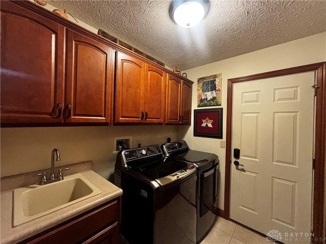 2460 Coriander Ct, Troy, OH 45373 - laundry room featuring cabinet space, washer and clothes dryer, a textured ceiling, and light tile patterned floors