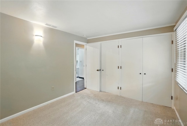 450 Ridgewood Ave, Oakwood, OH 45409 - unfurnished bedroom with light carpet, baseboards, and multiple closets