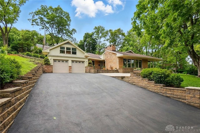 450 Ridgewood Ave, Oakwood, OH 45409 - view of front of house featuring driveway, a garage, and a chimney