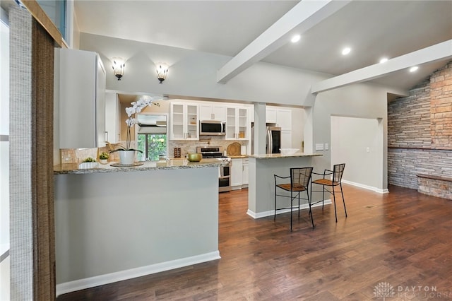 450 Ridgewood Ave, Oakwood, OH 45409 - kitchen with stainless steel appliances, a peninsula, tasteful backsplash, white cabinetry, and glass insert cabinets