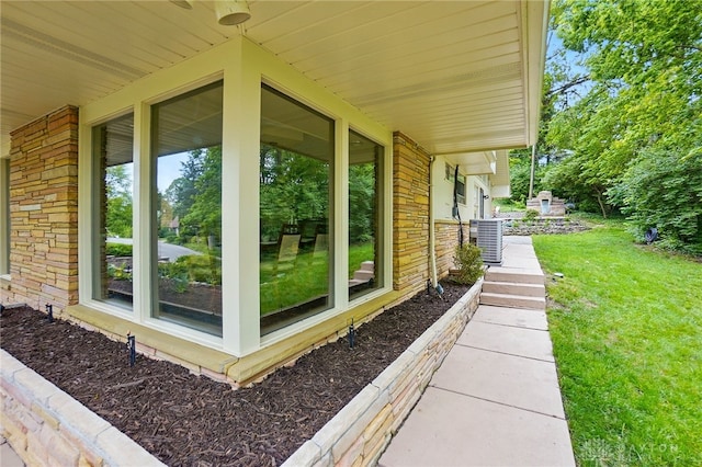 450 Ridgewood Ave, Oakwood, OH 45409 - view of property exterior with cooling unit, a lawn, stone siding, and brick siding