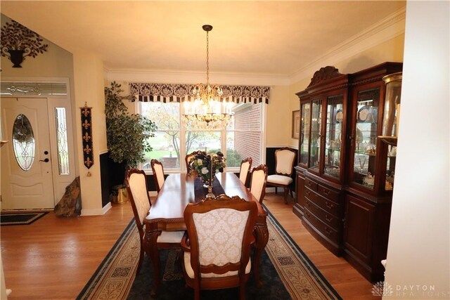 9543 Hacker Farm Ln, Centerville, OH 45458 - dining room featuring a chandelier, light wood-style flooring, crown molding, and baseboards