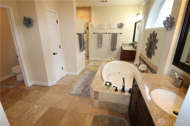 9543 Hacker Farm Ln, Centerville, OH 45458 - bathroom featuring a bath, two vanities, a shower stall, stone finish floors, and baseboards