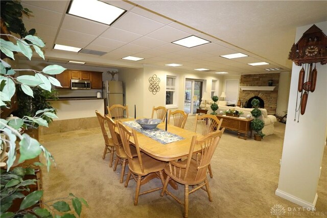 9543 Hacker Farm Ln, Centerville, OH 45458 - dining space featuring light colored carpet and a fireplace