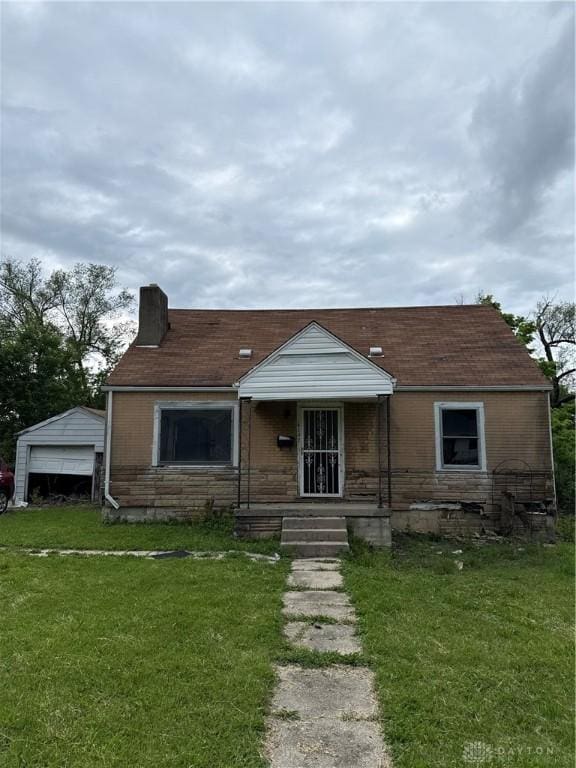 4157 Kammer Ave, Dayton, OH 45417 - bungalow-style house featuring a chimney, a front lawn, and a porch