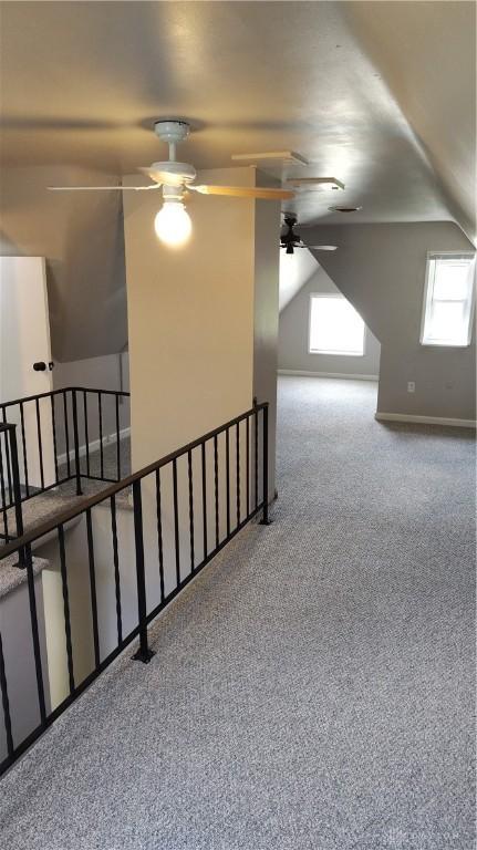 413 W Lake Ave, New Carlisle, OH 45344 - bonus room featuring a ceiling fan, vaulted ceiling, and carpet flooring