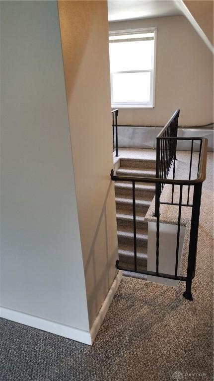 413 W Lake Ave, New Carlisle, OH 45344 - staircase with carpet floors and baseboards