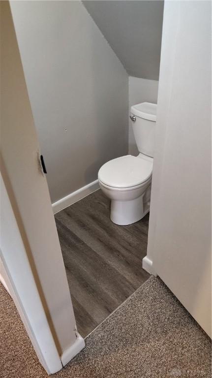 413 W Lake Ave, New Carlisle, OH 45344 - bathroom featuring toilet, baseboards, and wood finished floors