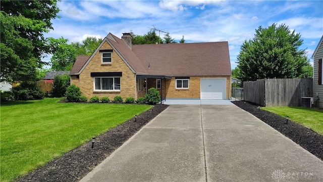 413 W Lake Ave, New Carlisle, OH 45344 - view of front facade featuring concrete driveway, a chimney, an attached garage, brick siding, and roof with shingles