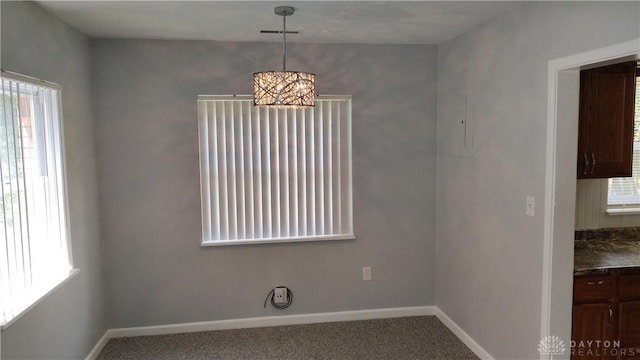 413 W Lake Ave, New Carlisle, OH 45344 - unfurnished dining area featuring carpet, plenty of natural light, and baseboards