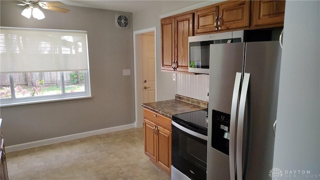 413 W Lake Ave, New Carlisle, OH 45344 - kitchen featuring appliances with stainless steel finishes, brown cabinetry, dark countertops, and baseboards