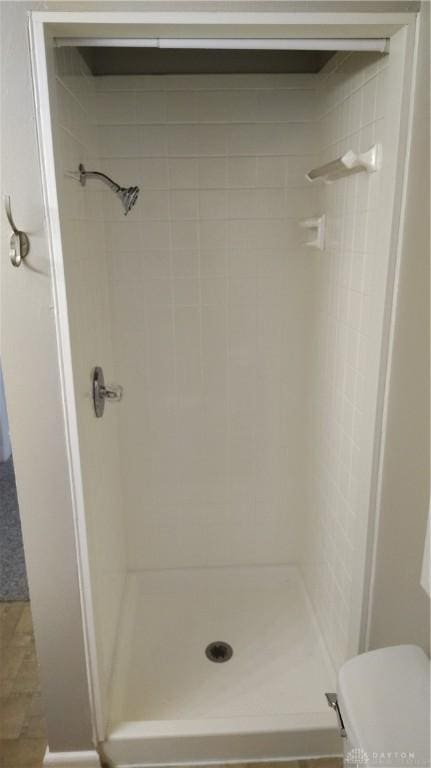 413 W Lake Ave, New Carlisle, OH 45344 - bathroom featuring a stall shower and toilet