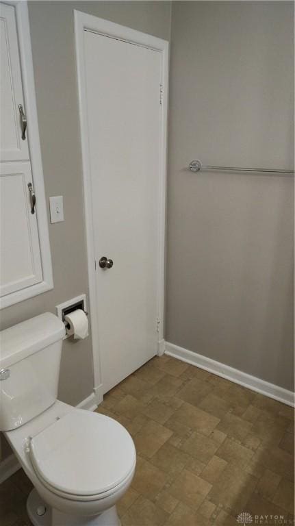 413 W Lake Ave, New Carlisle, OH 45344 - bathroom with toilet and baseboards