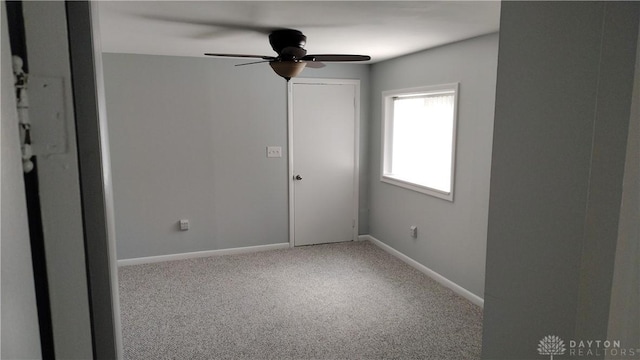 413 W Lake Ave, New Carlisle, OH 45344 - empty room featuring a ceiling fan, carpet flooring, and baseboards