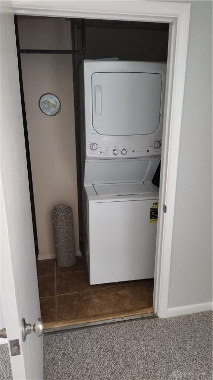 413 W Lake Ave, New Carlisle, OH 45344 - laundry room featuring stacked washer and clothes dryer and baseboards