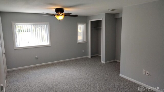 413 W Lake Ave, New Carlisle, OH 45344 - unfurnished bedroom featuring carpet, baseboards, a closet, and ceiling fan