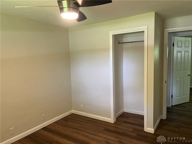 8700 Adams Rd, Dayton, OH 45424 - unfurnished bedroom with baseboards, dark wood-type flooring, a closet, and a ceiling fan