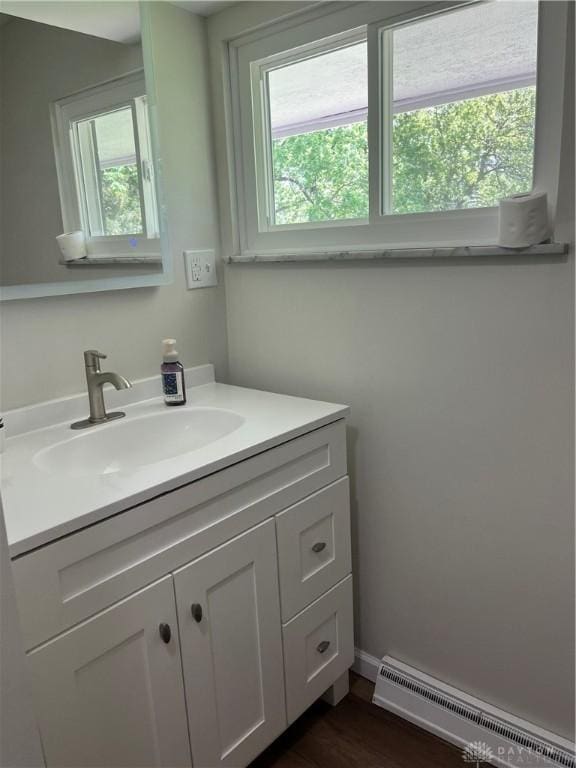 8700 Adams Rd, Dayton, OH 45424 - bathroom featuring baseboard heating, plenty of natural light, vanity, and wood finished floors
