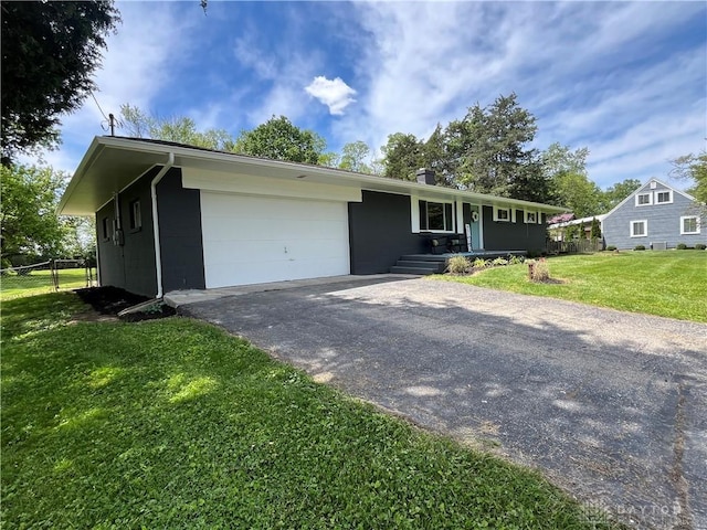 8700 Adams Rd, Dayton, OH 45424 - ranch-style home with asphalt driveway and a garage