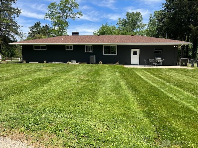 8700 Adams Rd, Dayton, OH 45424 - back of house featuring a patio, central AC unit, and a chimney