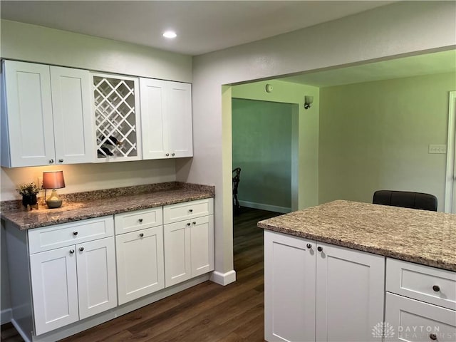 8700 Adams Rd, Dayton, OH 45424 - kitchen featuring dark wood finished floors, white cabinets, recessed lighting, baseboards, and dark stone counters