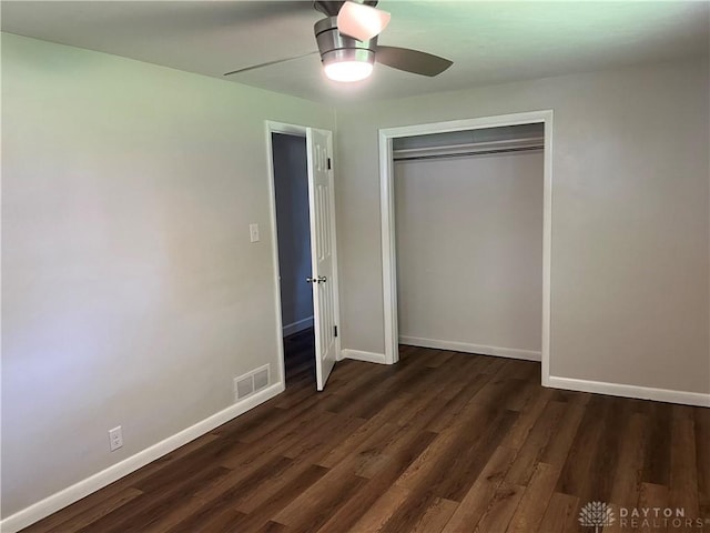 8700 Adams Rd, Dayton, OH 45424 - unfurnished bedroom with dark wood-style flooring, baseboards, a closet, and ceiling fan