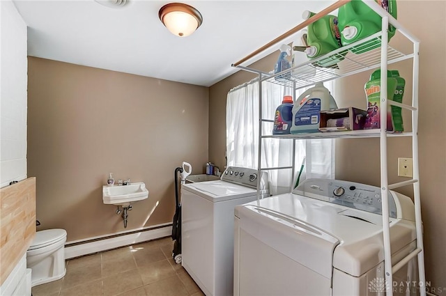 319 Camborne Dr, Englewood, OH 45322 - laundry area featuring a baseboard radiator, washer and dryer, and tile patterned flooring