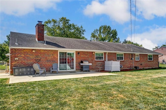 319 Camborne Dr, Englewood, OH 45322 - rear view of property featuring a patio area, a chimney, brick siding, and a yard