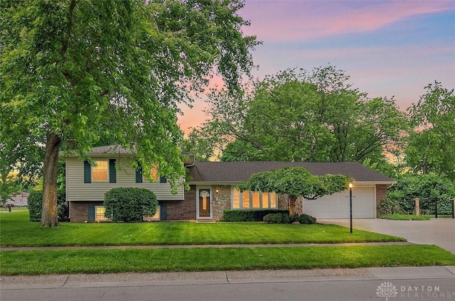 5135 Lamonte Dr, Fairfield, OH 45014 - tri-level home with driveway, a garage, a front lawn, and brick siding