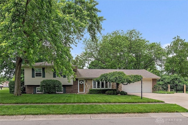 5135 Lamonte Dr, Fairfield, OH 45014 - tri-level home with an attached garage, concrete driveway, a front yard, and brick siding