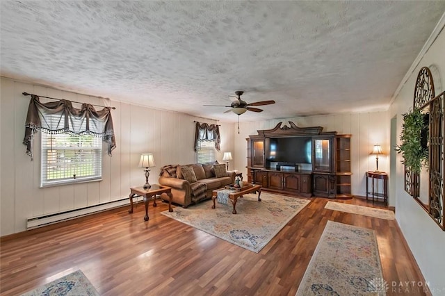 5135 Lamonte Dr, Fairfield, OH 45014 - living area featuring a baseboard heating unit, a textured ceiling, healthy amount of natural light, wood finished floors, and ceiling fan