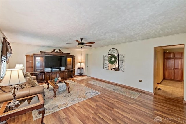 5135 Lamonte Dr, Fairfield, OH 45014 - living room with a ceiling fan, wood finished floors, a textured ceiling, and baseboards