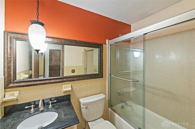 5135 Lamonte Dr, Fairfield, OH 45014 - full bathroom with enclosed tub / shower combo, vanity, toilet, and tile walls