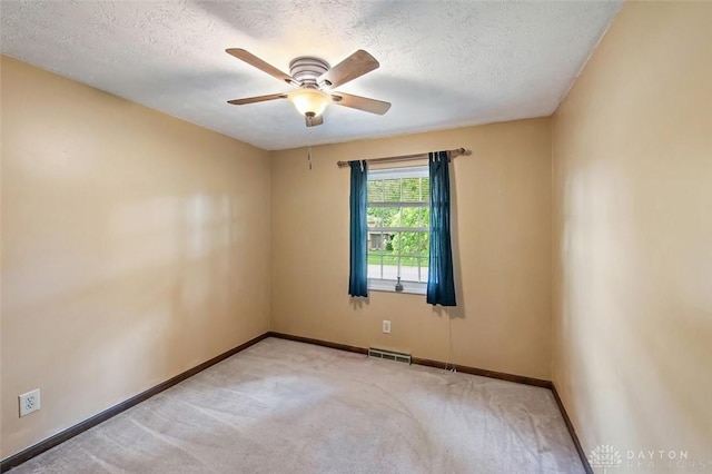 5135 Lamonte Dr, Fairfield, OH 45014 - unfurnished room with carpet floors, baseboards, a ceiling fan, and a textured ceiling