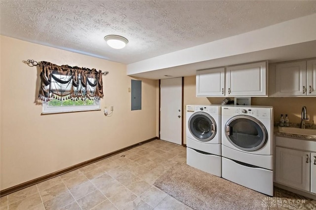 5135 Lamonte Dr, Fairfield, OH 45014 - laundry area featuring cabinet space, electric panel, washing machine and dryer, a textured ceiling, and baseboards