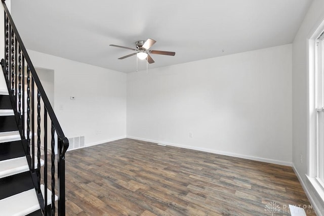 1050 Frederick Dr, Xenia, OH 45385 - empty room with ceiling fan, stairs, dark wood-style floors, and baseboards
