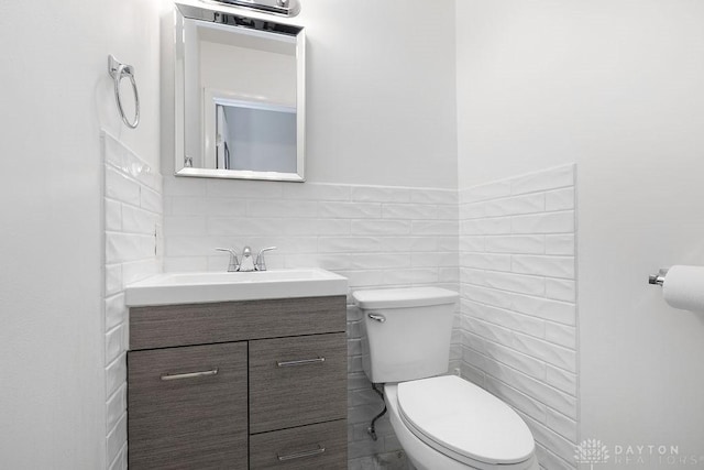 1050 Frederick Dr, Xenia, OH 45385 - bathroom featuring toilet, vanity, and tile walls
