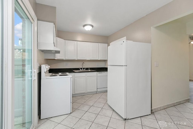 1050 Frederick Dr, Xenia, OH 45385 - kitchen featuring white appliances, a sink, dark countertops, and light tile patterned floors