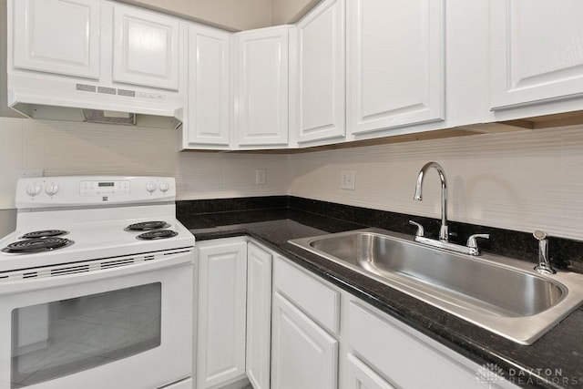 1050 Frederick Dr, Xenia, OH 45385 - kitchen featuring white range with electric cooktop, under cabinet range hood, a sink, and white cabinetry