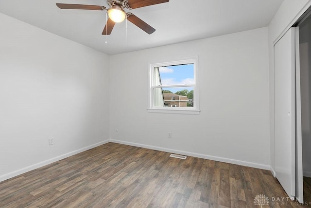 1050 Frederick Dr, Xenia, OH 45385 - unfurnished bedroom with a closet, baseboards, wood finished floors, and a ceiling fan