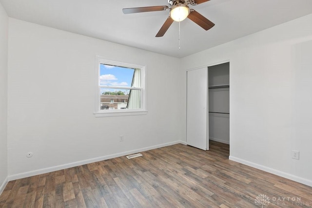 1050 Frederick Dr, Xenia, OH 45385 - unfurnished bedroom featuring baseboards, wood finished floors, a closet, and a ceiling fan