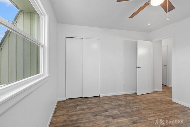 1050 Frederick Dr, Xenia, OH 45385 - unfurnished bedroom with wood finished floors, baseboards, a closet, and ceiling fan