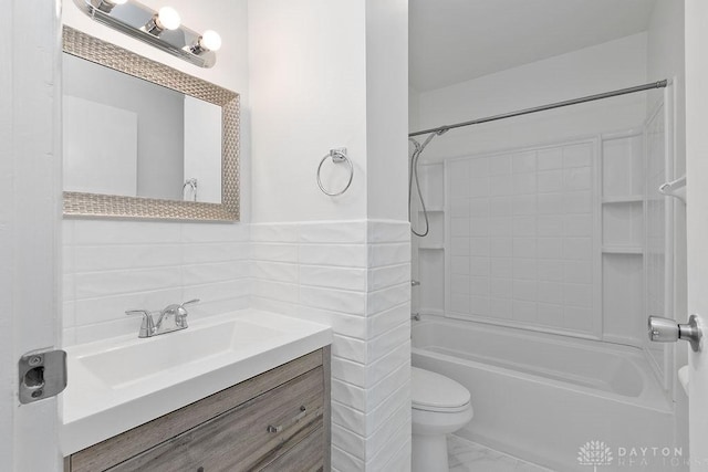 1050 Frederick Dr, Xenia, OH 45385 - full bathroom with marble finish floors, toilet, shower / washtub combination, vanity, and tile walls