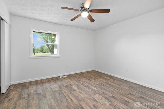 1050 Frederick Dr, Xenia, OH 45385 - unfurnished bedroom featuring wood finished floors, baseboards, a closet, a textured ceiling, and ceiling fan